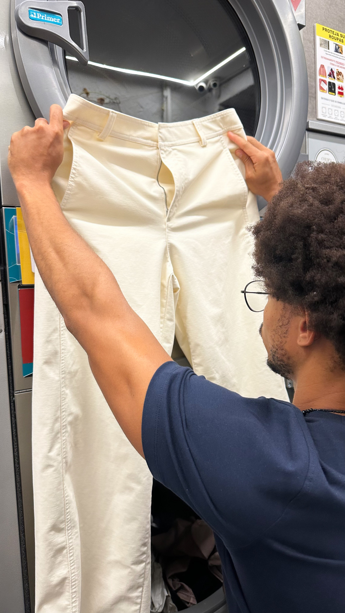 Careful inspection of cream trousers at the laundry